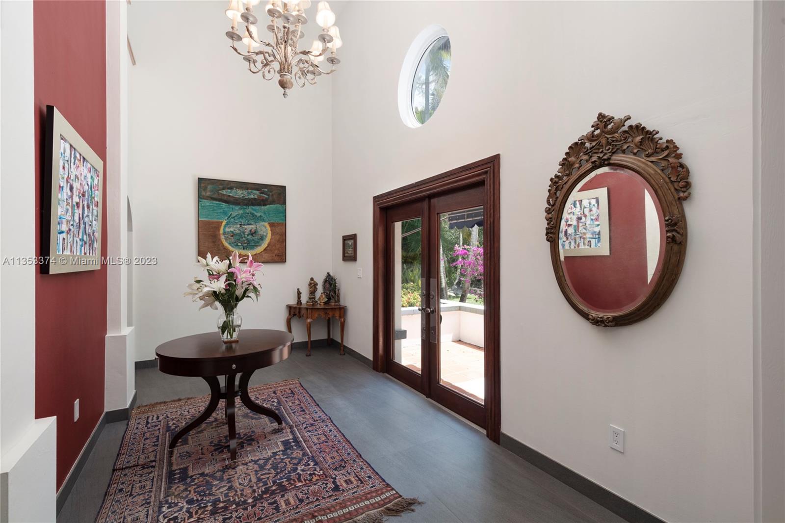 6745 Southwest 94th Street Pinecrest, FL 33156 - Photo 8 of 24 a living room with furniture and a mirror