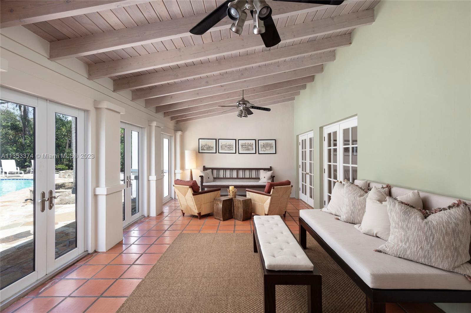 6745 Southwest 94th Street Pinecrest, FL 33156 - Photo 9 of 24 a living room with furniture fireplace and large windows
