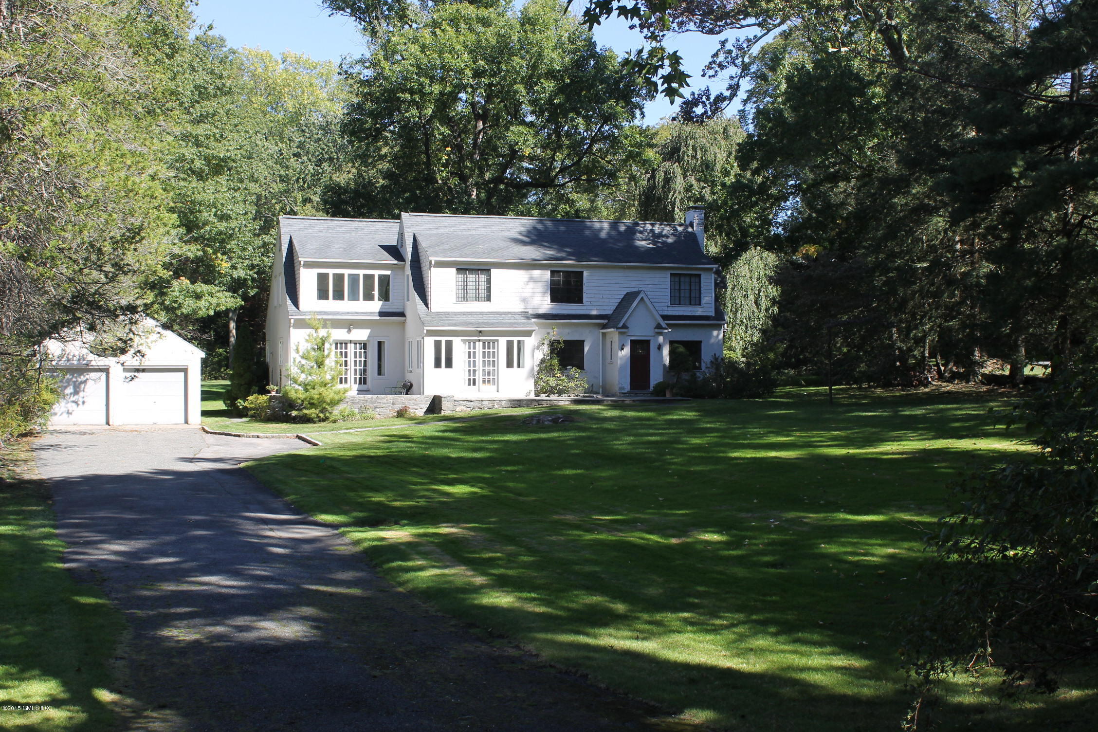 32 Gilliam Lane Riverside, CT 06878 - Photo 4 of 4 a front view of a house with a yard