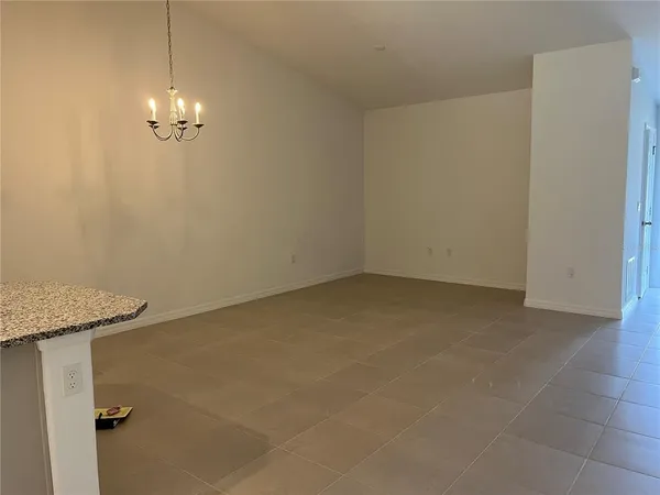a view of a chandelier fan in big room