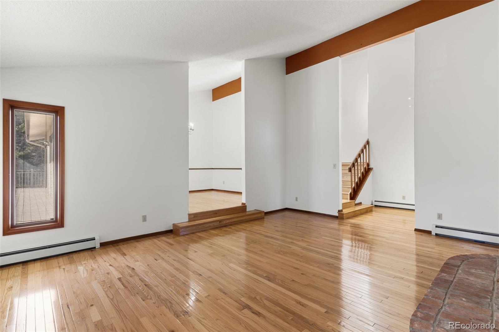 485 West Woodmen Road Colorado Springs, CO 80919 - Photo 13 of 50 an empty room with wooden floor and white walls