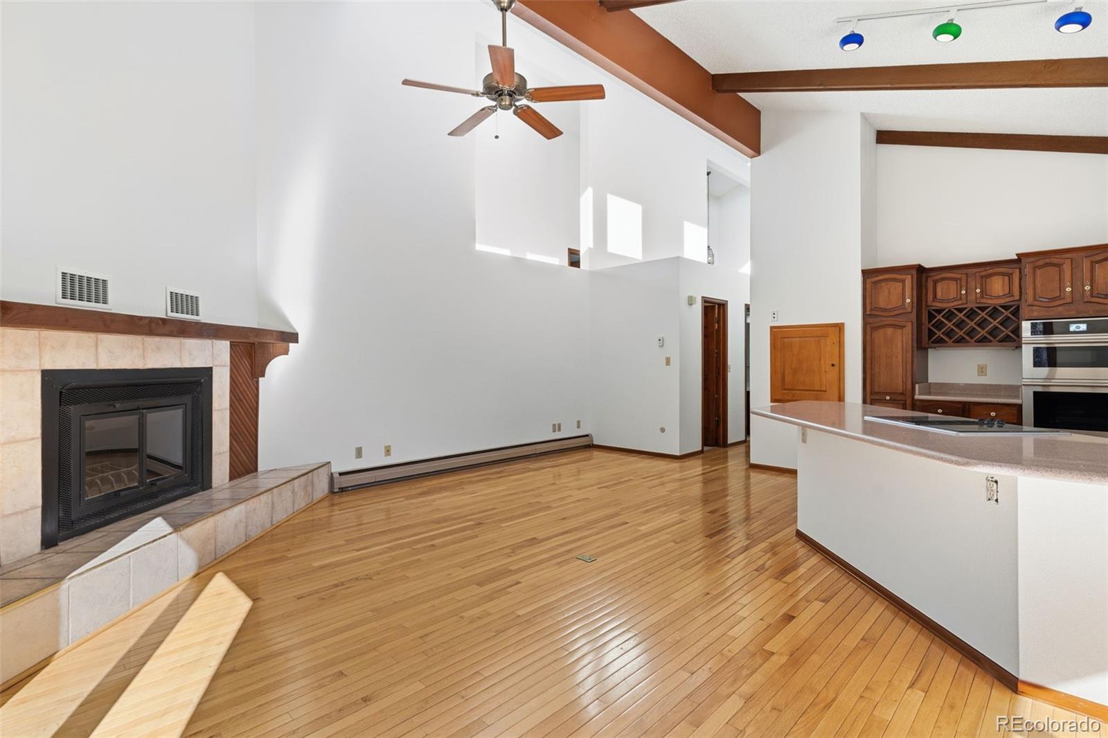 485 West Woodmen Road Colorado Springs, CO 80919 - Photo 16 of 50 a view of a kitchen with wooden floor and a fireplace