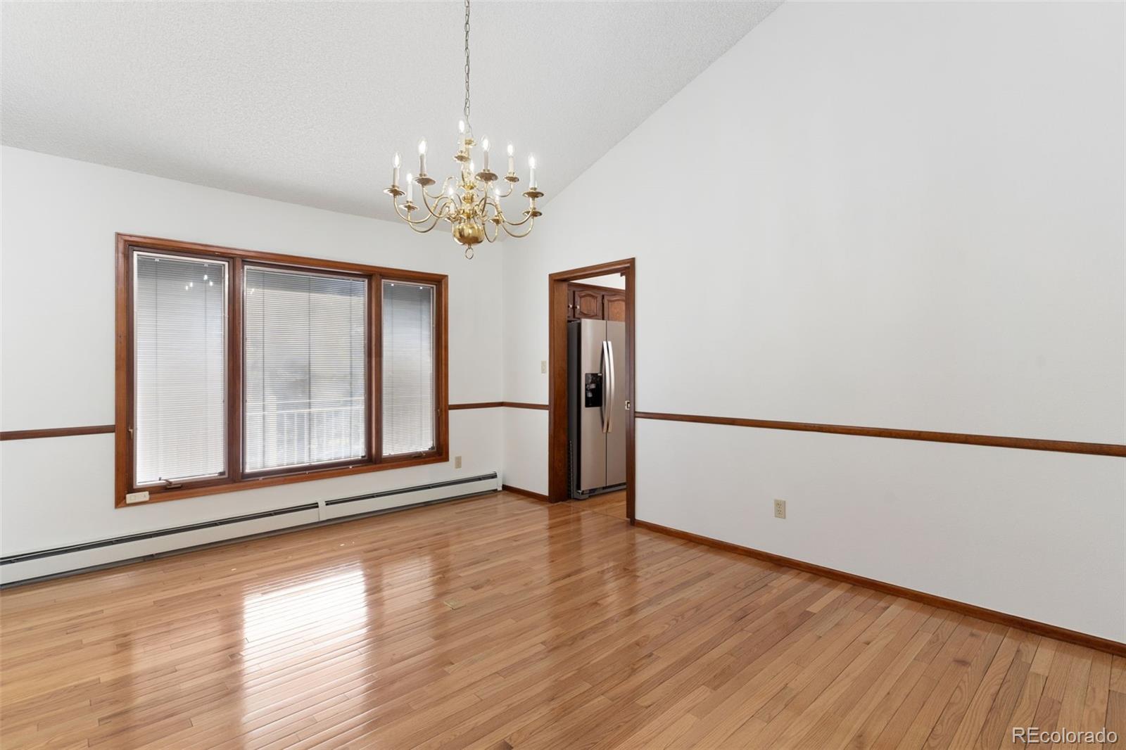485 West Woodmen Road Colorado Springs, CO 80919 - Photo 18 of 50 a view of an empty room with a window and wooden floor
