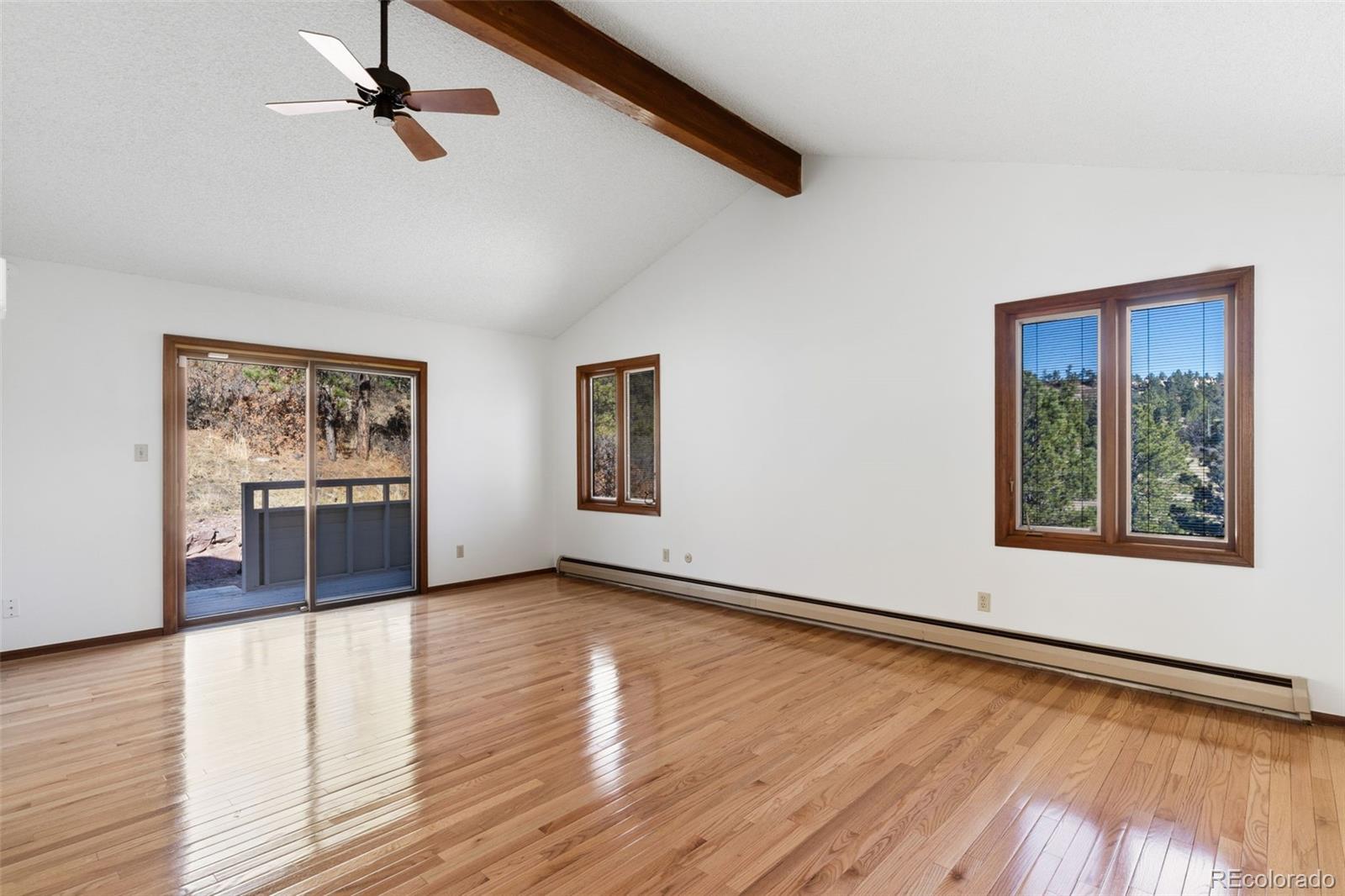 485 West Woodmen Road Colorado Springs, CO 80919 - Photo 25 of 50 a view of an empty room with wooden floor and a window