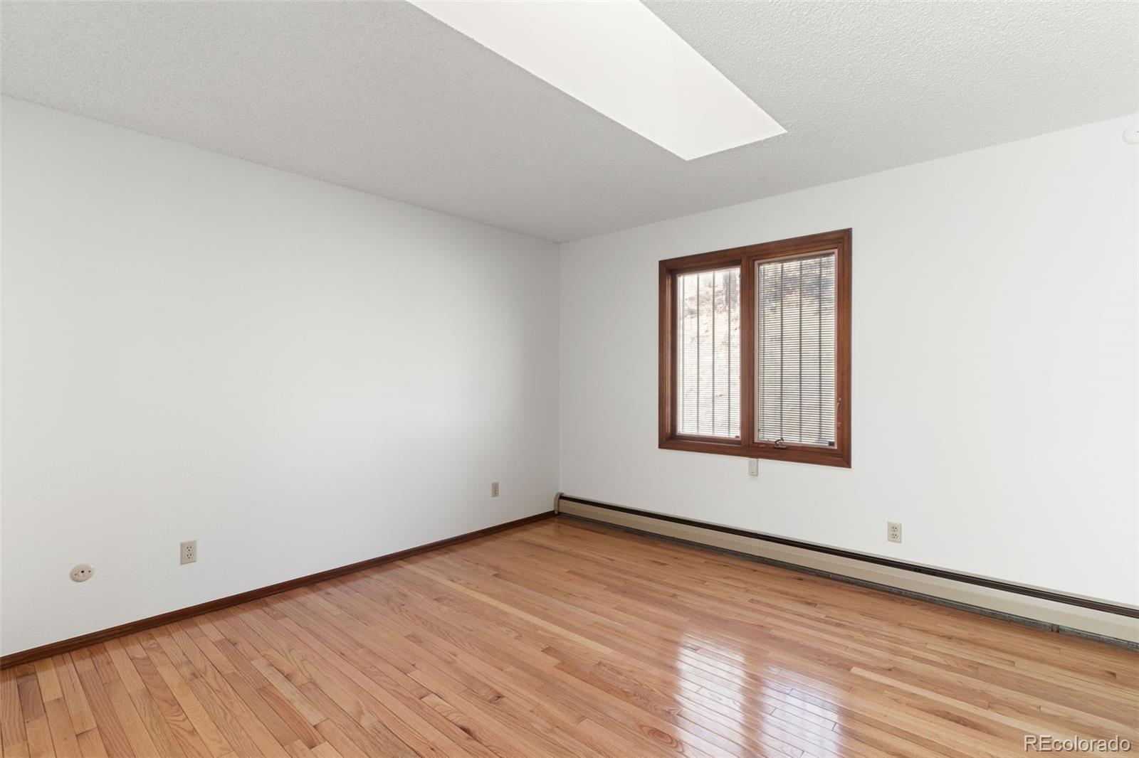 485 West Woodmen Road Colorado Springs, CO 80919 - Photo 29 of 50 an empty room with wooden floor and windows