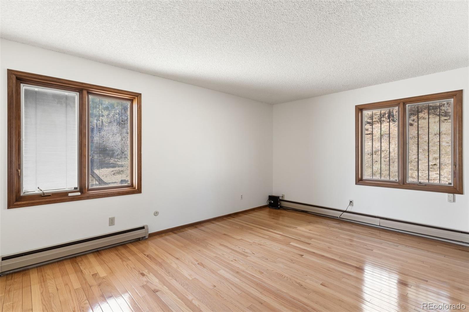 485 West Woodmen Road Colorado Springs, CO 80919 - Photo 30 of 50 a view of an empty room with wooden floor and a window
