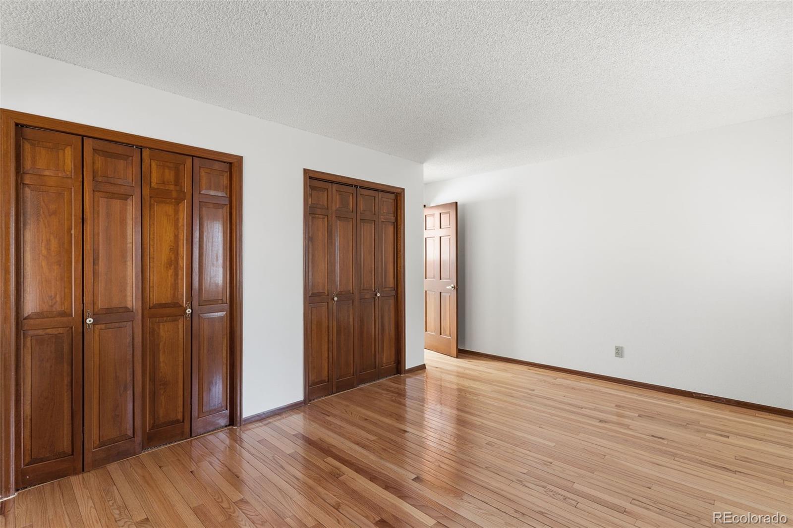 485 West Woodmen Road Colorado Springs, CO 80919 - Photo 31 of 50 a view of an empty room with wooden floor