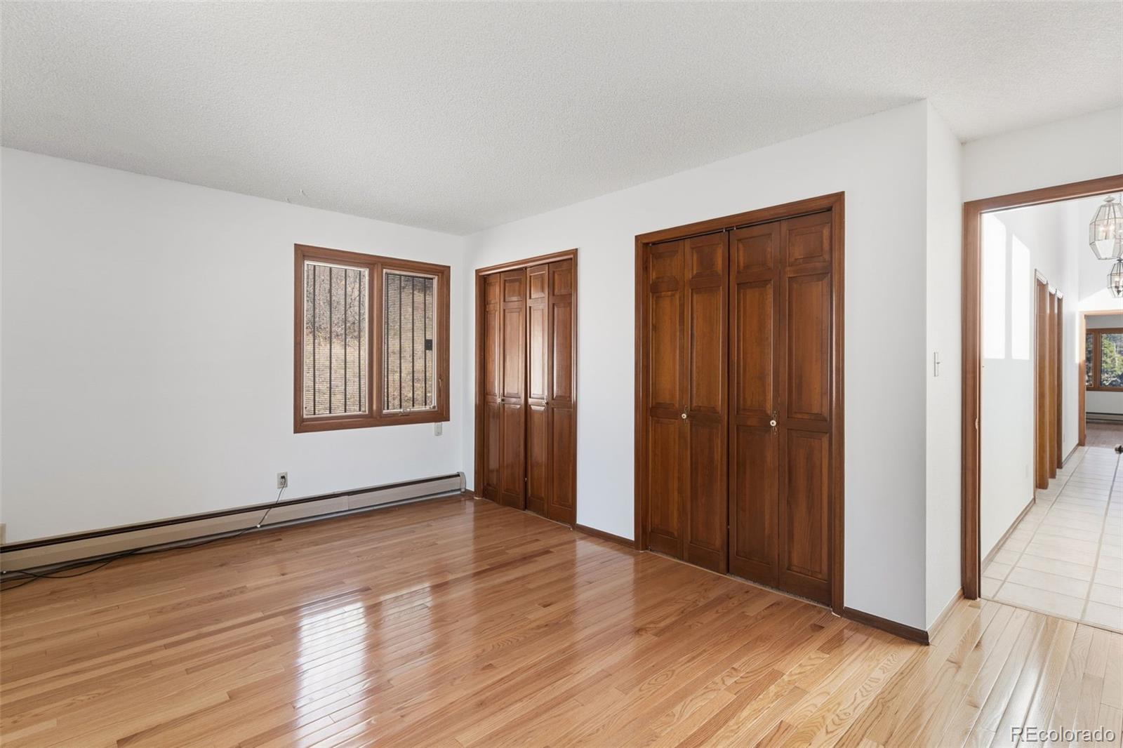 485 West Woodmen Road Colorado Springs, CO 80919 - Photo 32 of 50 a view of an empty room with wooden floor and a window