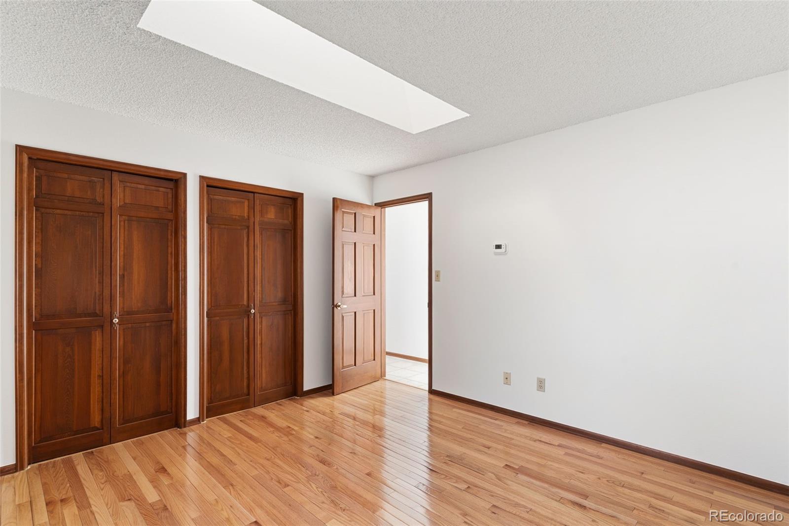 485 West Woodmen Road Colorado Springs, CO 80919 - Photo 33 of 50 a view of an empty room with wooden floor