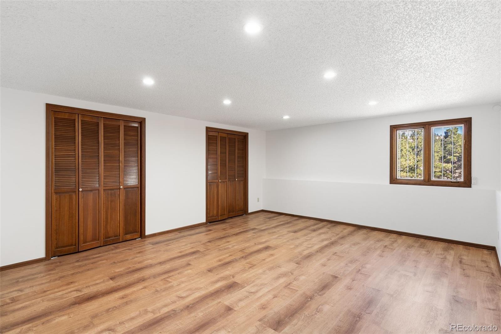 485 West Woodmen Road Colorado Springs, CO 80919 - Photo 34 of 50 a view of an empty room with wooden floor and closet