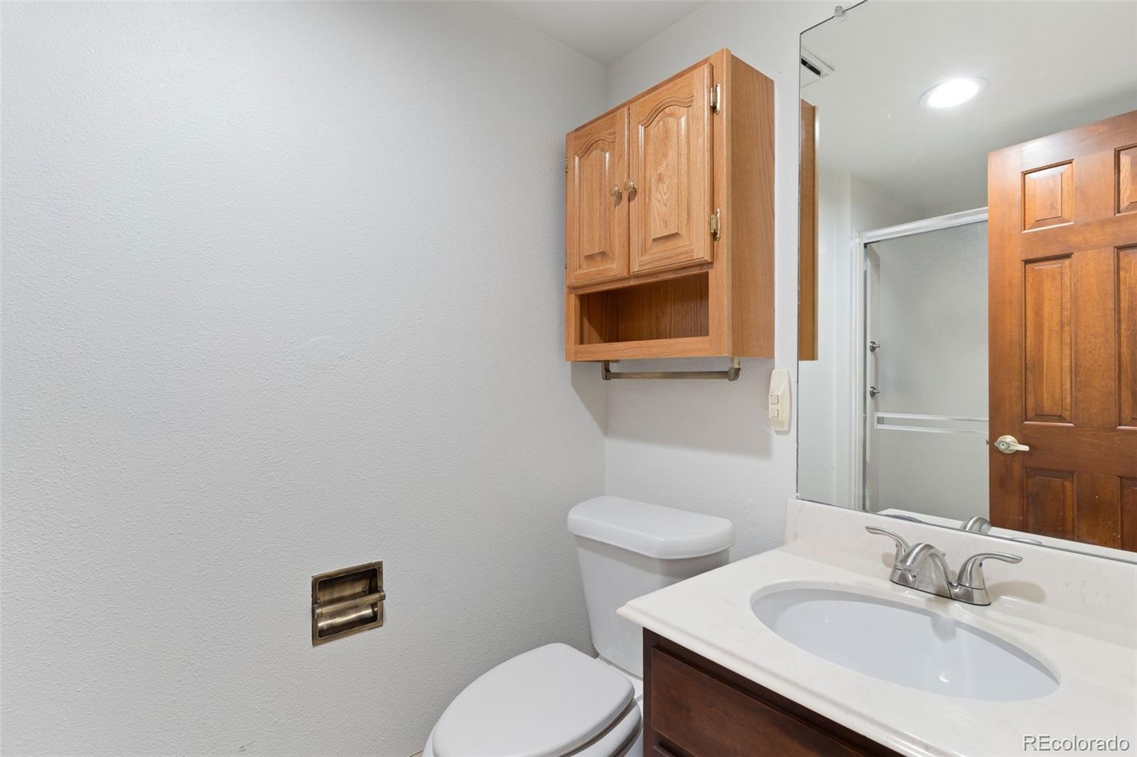 485 West Woodmen Road Colorado Springs, CO 80919 - Photo 36 of 50 a bathroom with a sink toilet and mirror