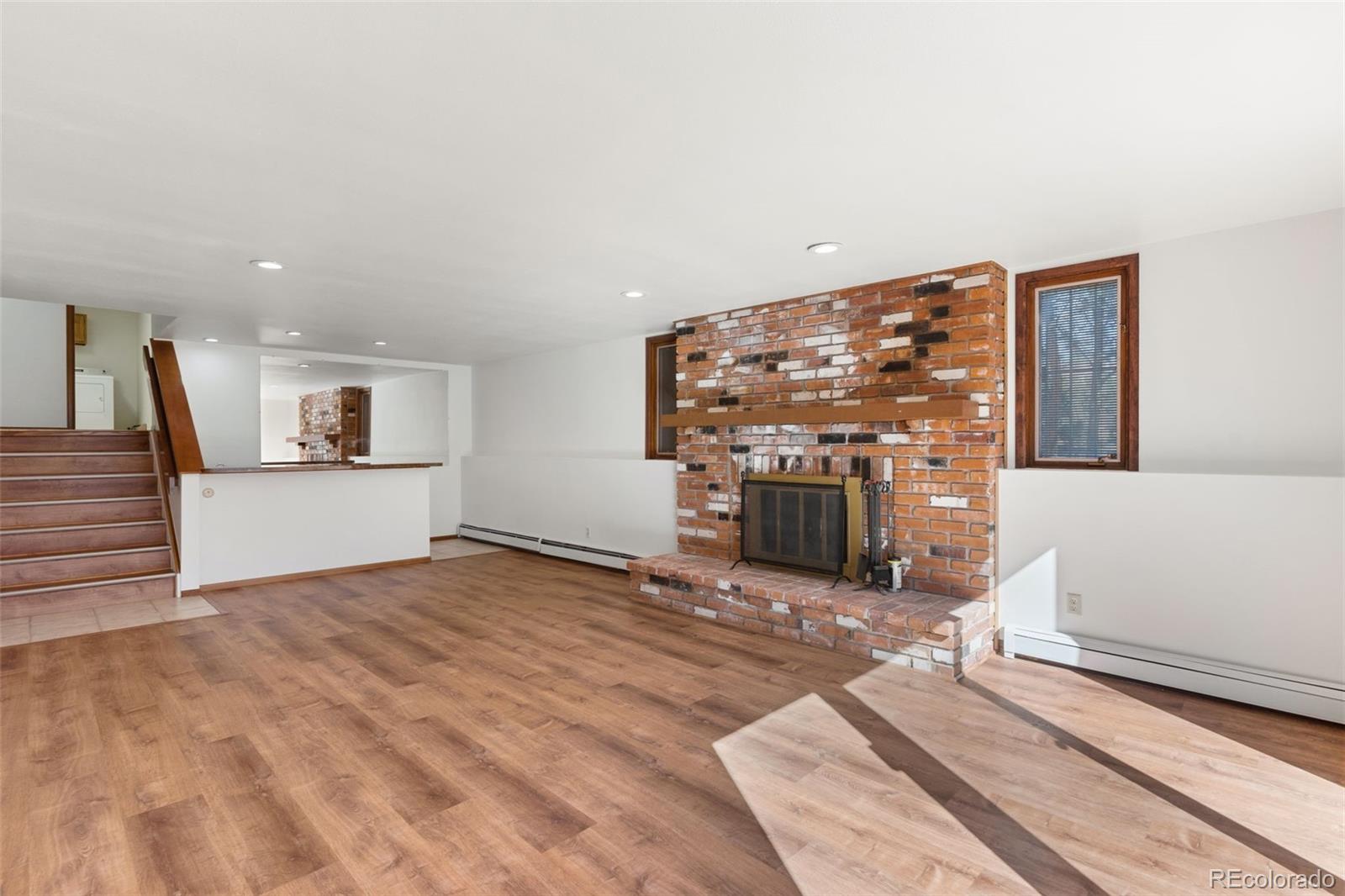 485 West Woodmen Road Colorado Springs, CO 80919 - Photo 37 of 50 a view of a livingroom with wooden floor and a fireplace