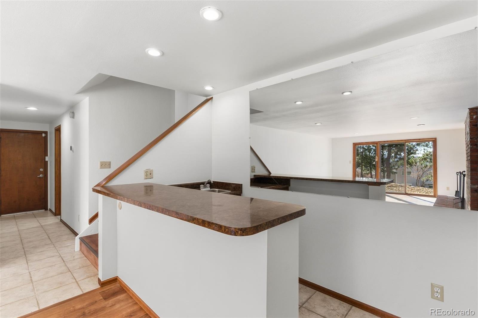 485 West Woodmen Road Colorado Springs, CO 80919 - Photo 39 of 50 a view of entryway and kitchen