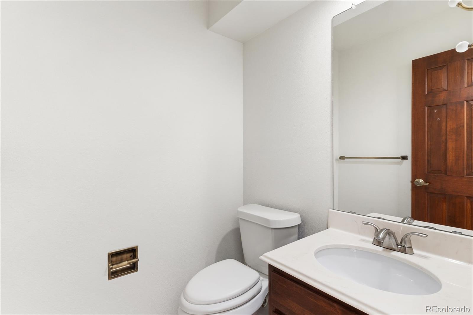485 West Woodmen Road Colorado Springs, CO 80919 - Photo 42 of 50 a bathroom with a sink a toilet and a mirror