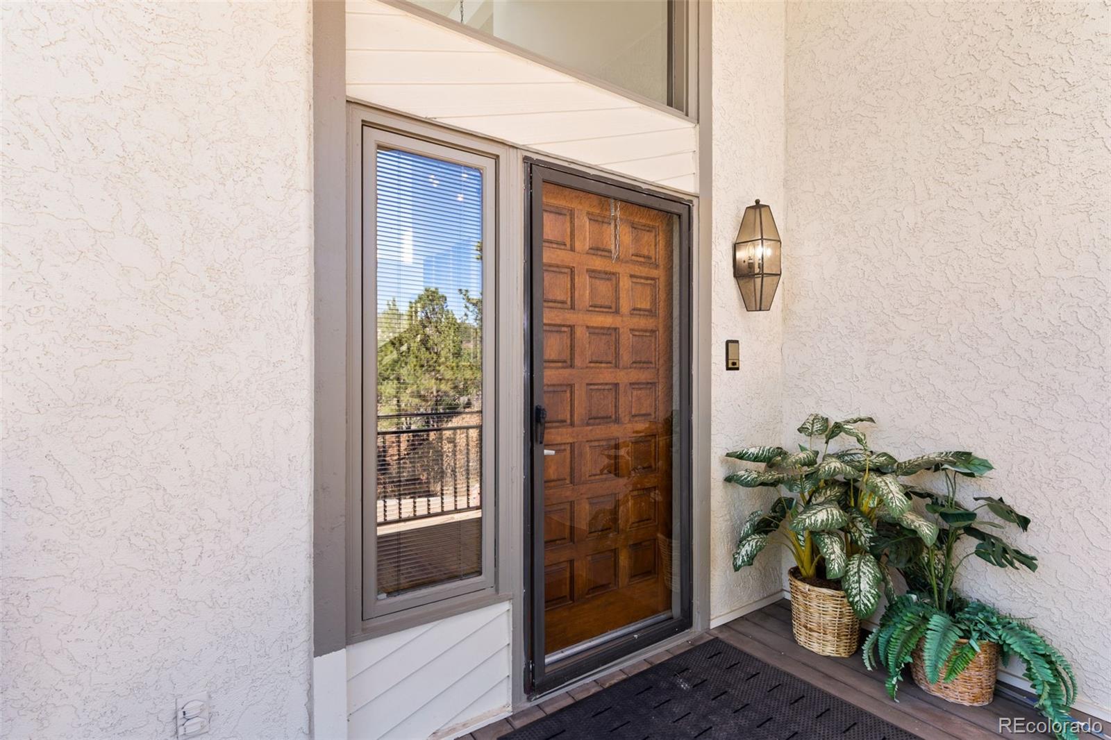 485 West Woodmen Road Colorado Springs, CO 80919 - Photo 7 of 50 a front view of a house with a potted plant
