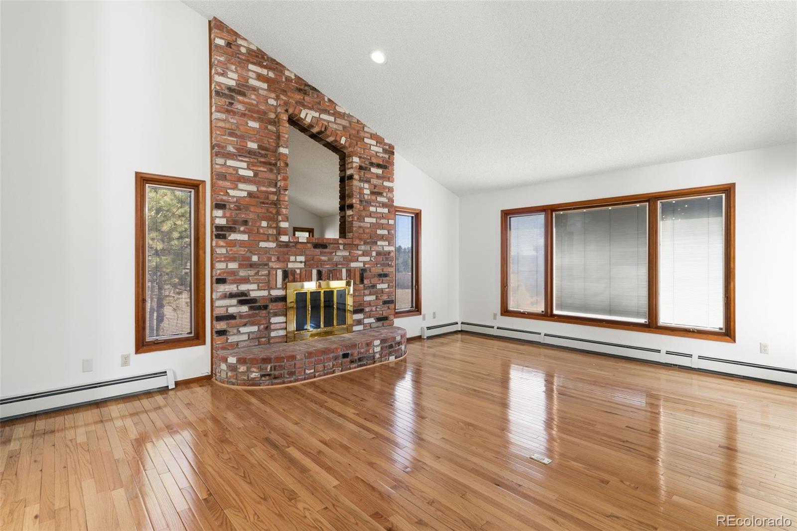 485 West Woodmen Road Colorado Springs, CO 80919 - Photo 10 of 50 a view of an empty room with wooden floor and a window