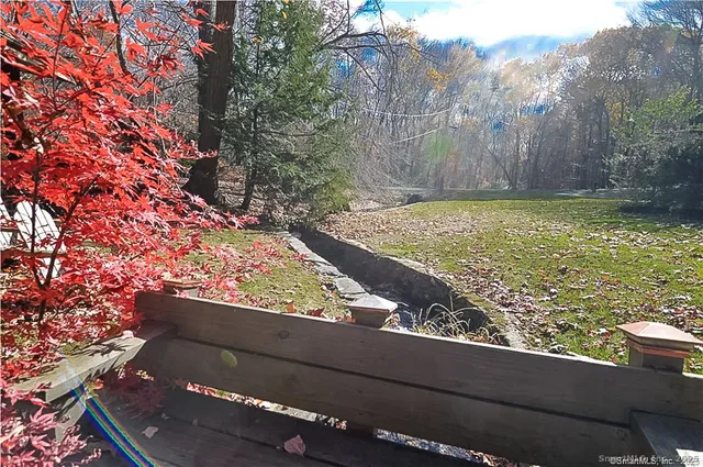 a view of a yard with wooden fence