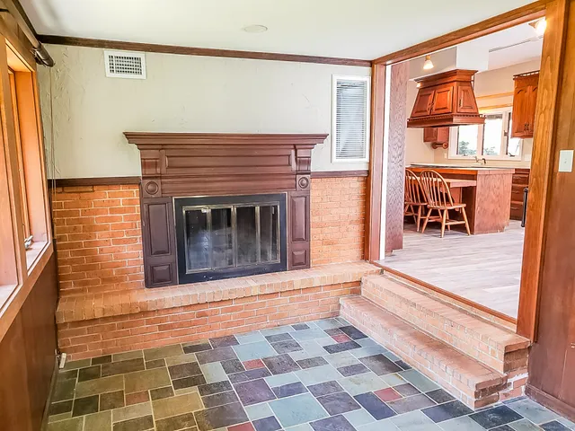 a living room with a fireplace and next to a window