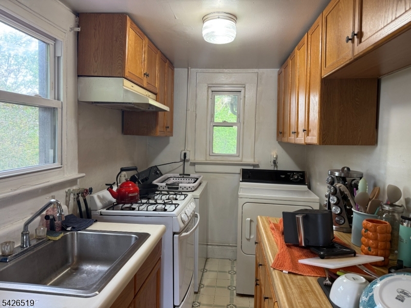 775 Bloomfield Avenue, Unit 2 Montclair, NJ 07042 - Photo 2 of 15 a kitchen with stainless steel appliances a sink a stove a microwave a refrigerator and cabinets