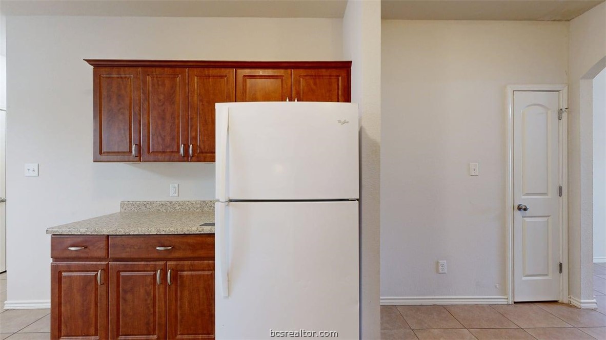 4453-4455 Reveille Road College Station, TX 77845 - Photo 26 of 37 a white refrigerator freezer sitting in a kitchen