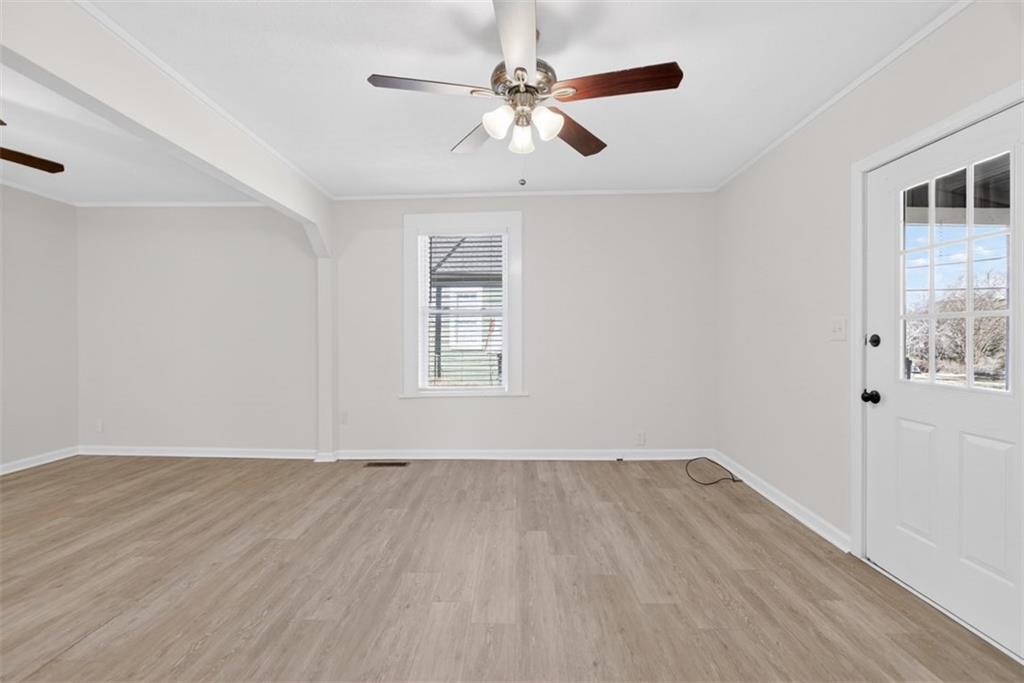 246 Spring Street Commerce, GA 30529 - Photo 4 of 23 wooden floor in an empty room with a window