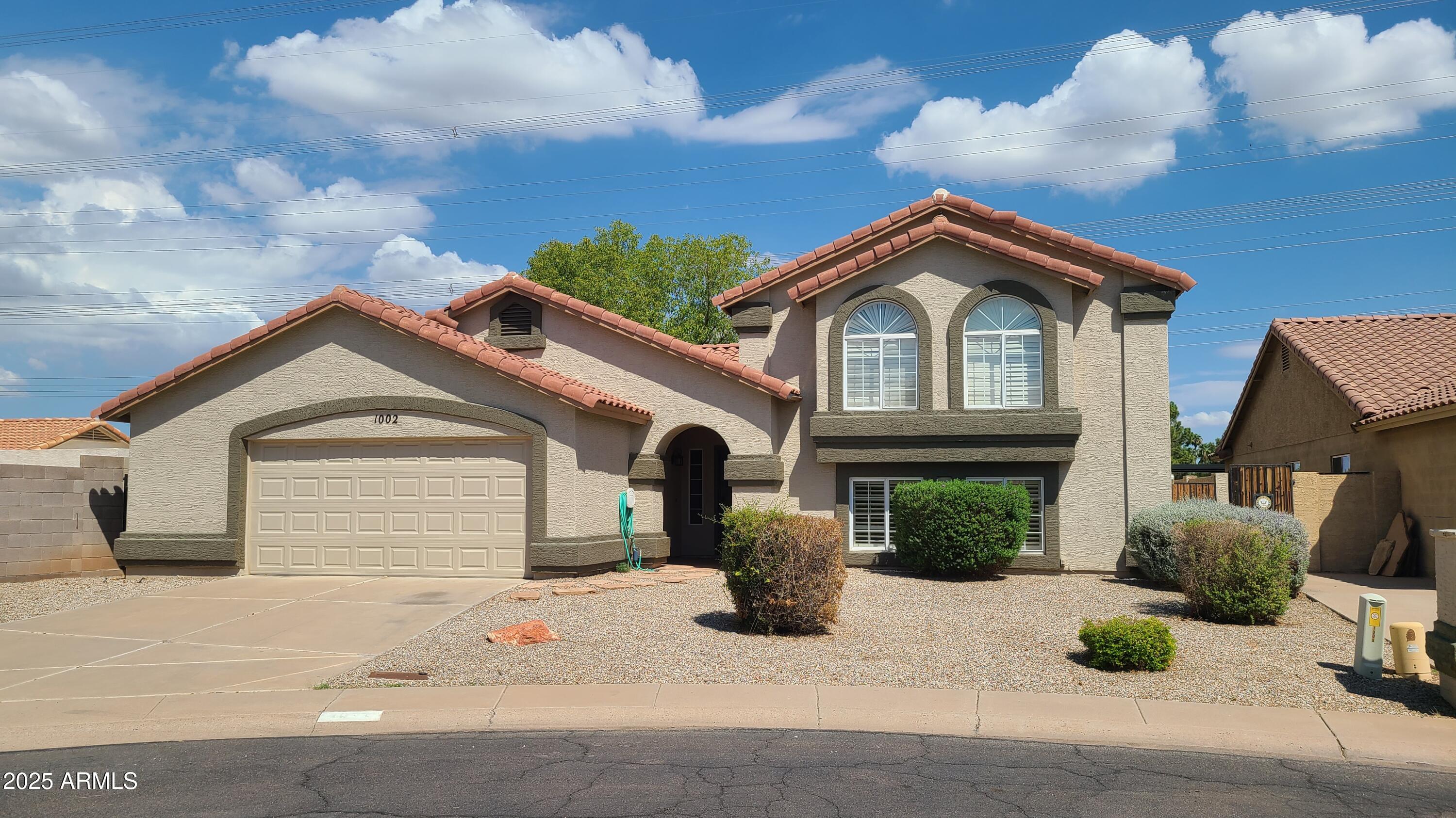 a front view of a house with garage