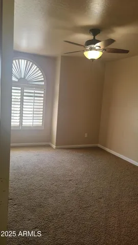 a kitchen with a refrigerator and a wooden floor