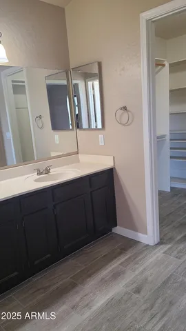 a view of walk in closet with empty racks