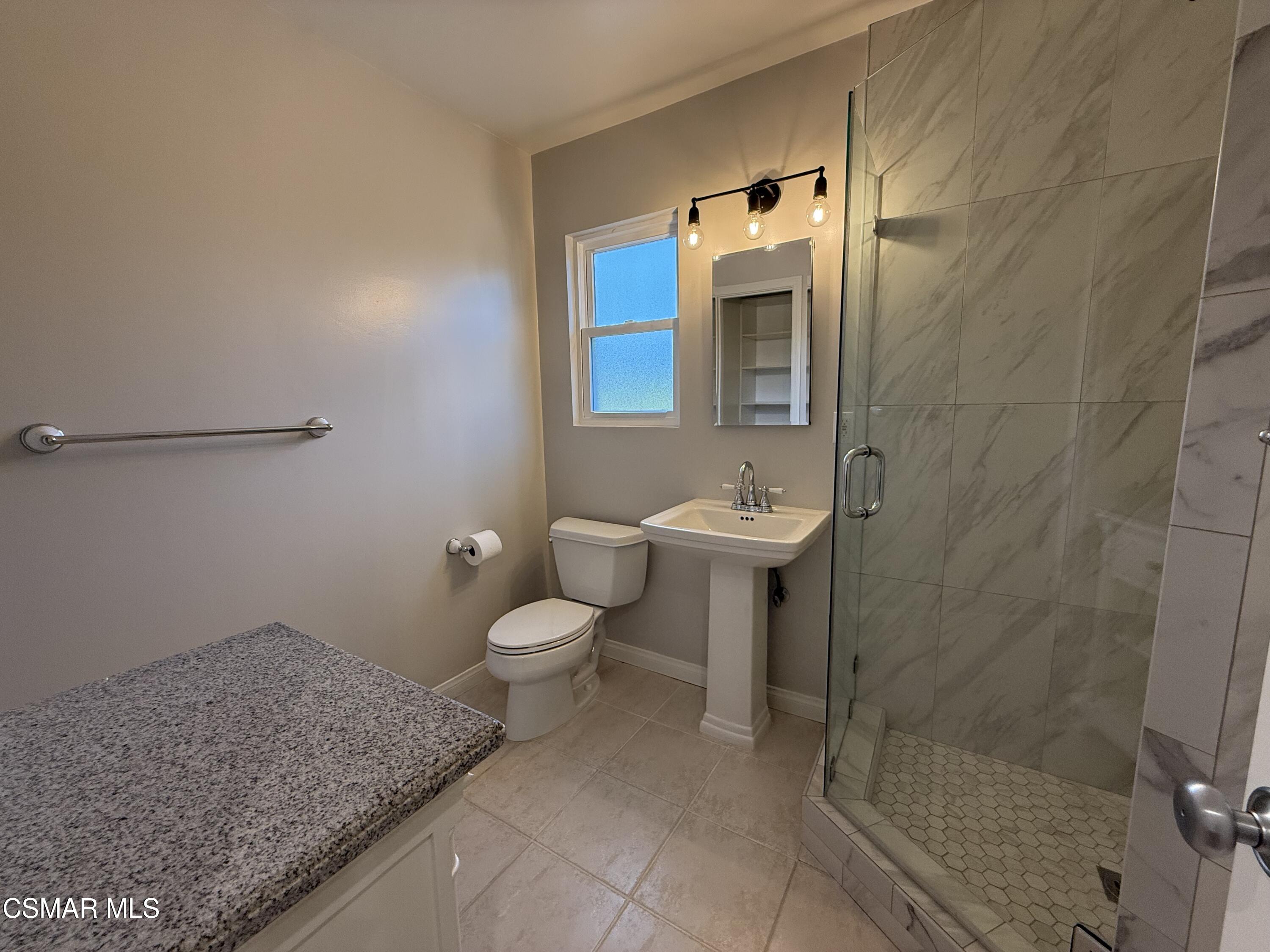 3446 Travis Avenue Simi Valley, CA 93063 - Photo 22 of 36 a bathroom with a granite countertop sink mirror and toilet