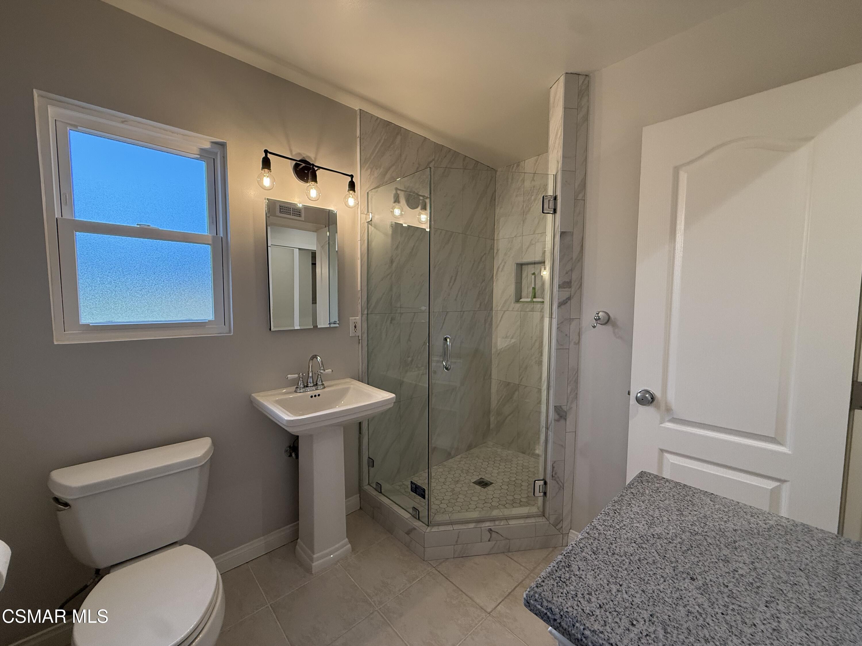 3446 Travis Avenue Simi Valley, CA 93063 - Photo 23 of 36 a bathroom with a toilet a sink and shower