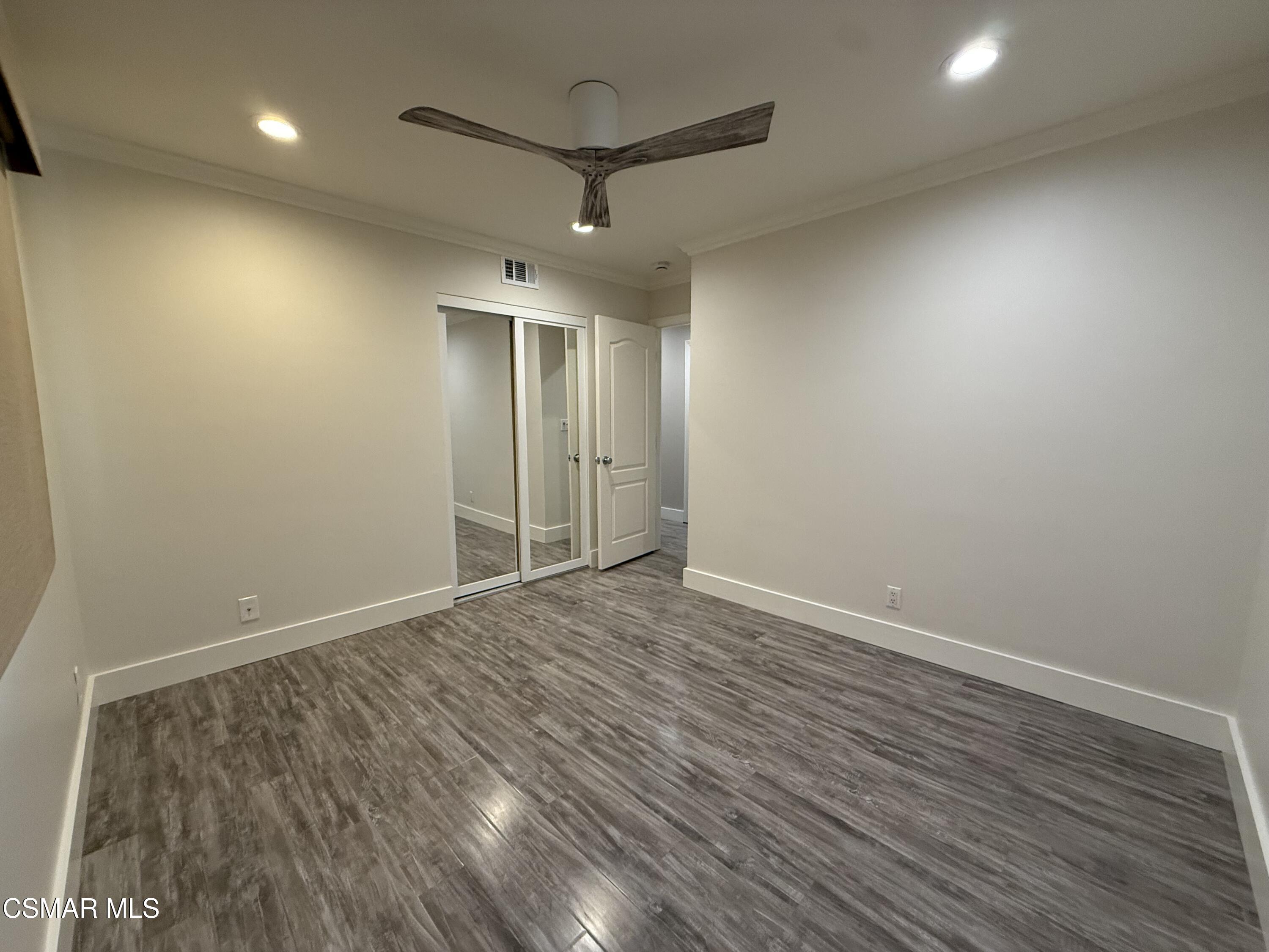 3446 Travis Avenue Simi Valley, CA 93063 - Photo 25 of 36 an empty room with wooden floor and a ceiling fan