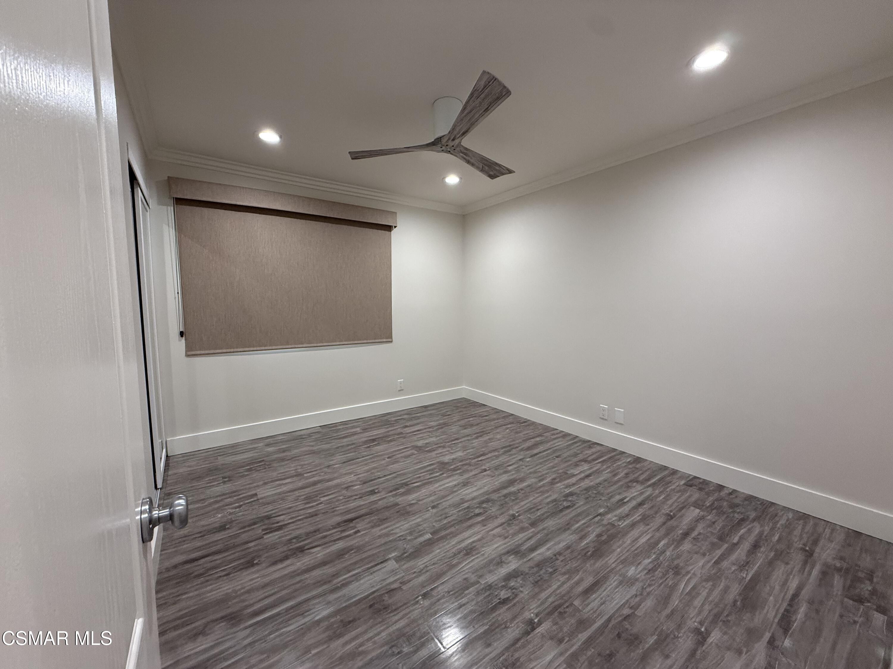 3446 Travis Avenue Simi Valley, CA 93063 - Photo 29 of 36 an empty room with wooden floor and windows