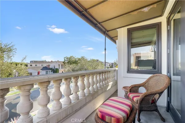 a balcony with wooden floor and outdoor seating