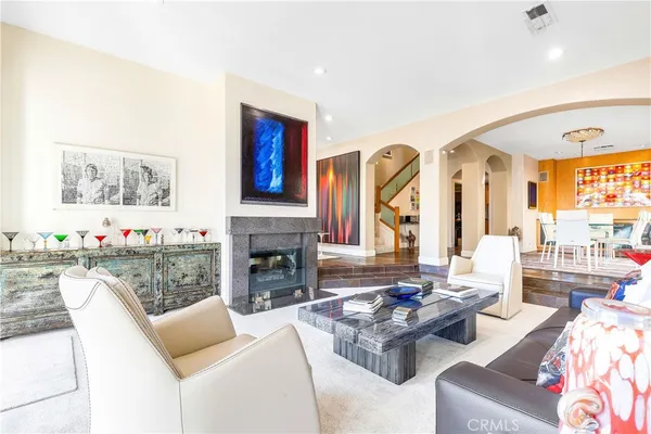 a living room with furniture fireplace and a large window