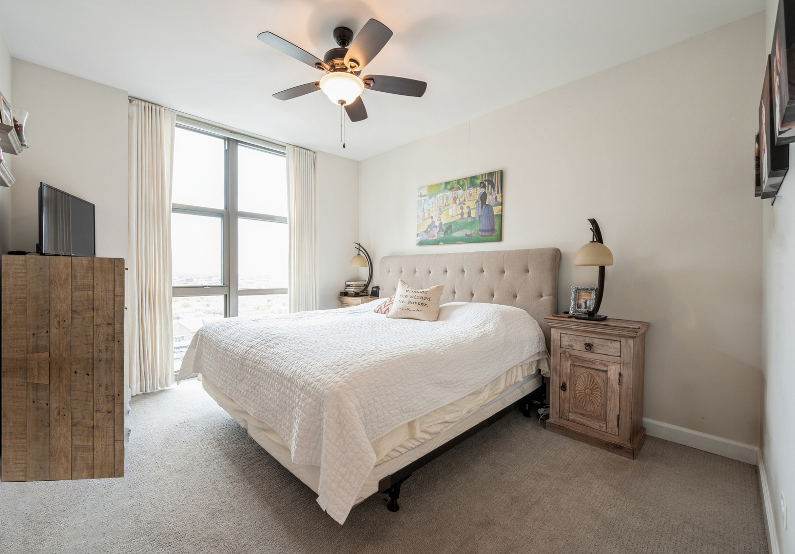 1101 South State Street, Unit H1504 Chicago, IL 60605 - Photo 6 of 16 a bedroom with a large bed and a window