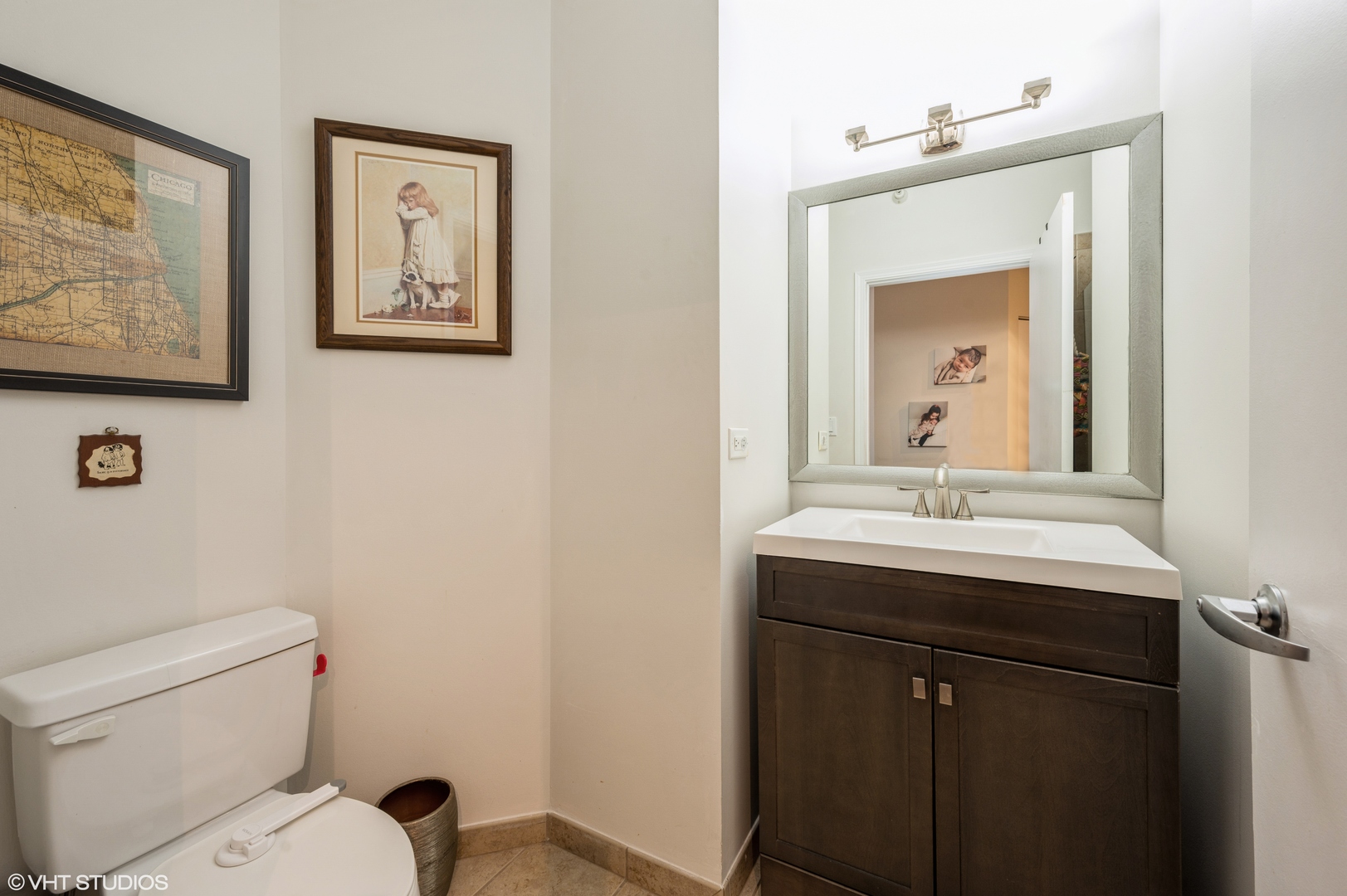 1101 South State Street, Unit H1504 Chicago, IL 60605 - Photo 9 of 16 a bathroom with a toilet a sink and mirror