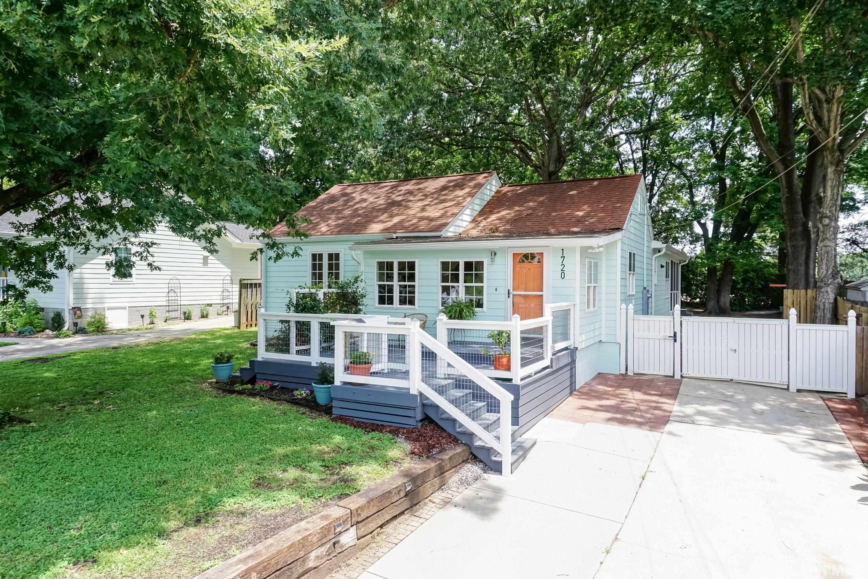 a house view with a sitting space and garden