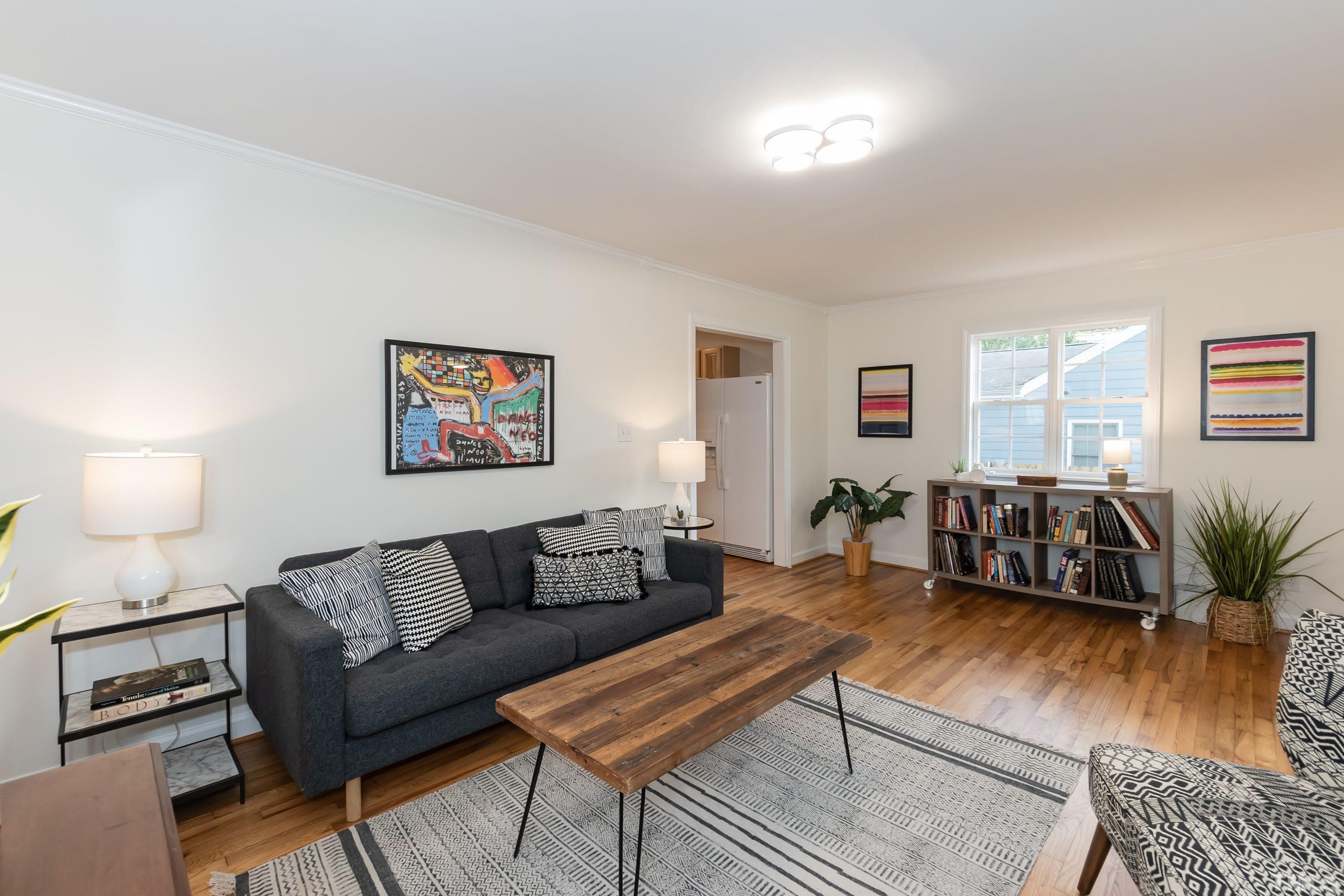 1720 Bennett Street Raleigh, NC 27604 - Photo 9 of 46 a living room with furniture a lamp a window and a potted plant