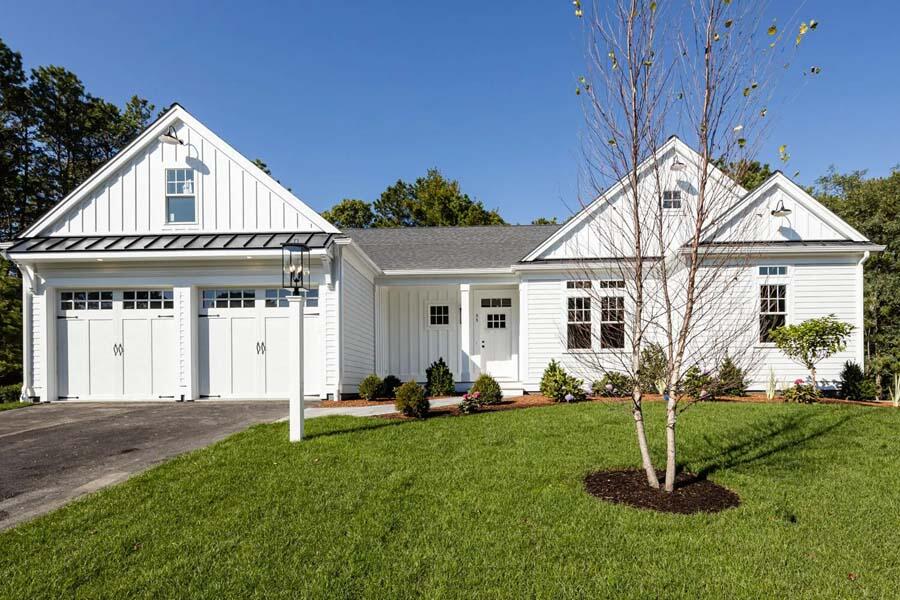 a view of a house with a yard and porch