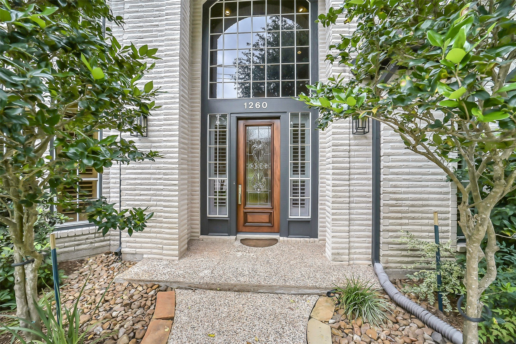 1260 Fries Road Houston, TX 77055 - Photo 2 of 42 Custom Design Brick and Custom Trim Paint meet you with a Soaring Arched Entry with Stunning Windows that shed tons off Natural Light into your home!