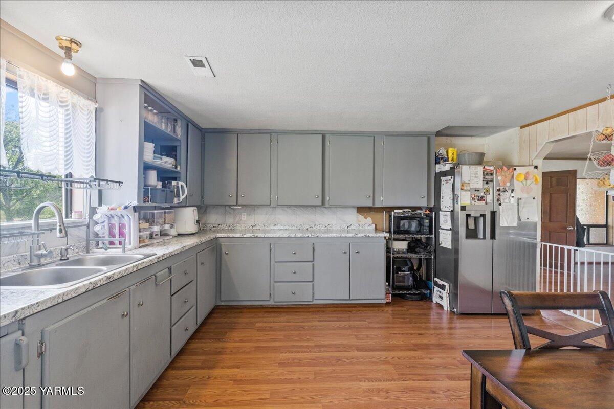101 West Slavin Road Yakima, WA 98903 - Photo 12 of 37 a kitchen with sink refrigerator and cabinets