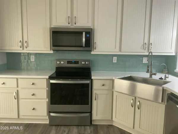 a kitchen with cabinets and a refrigerator