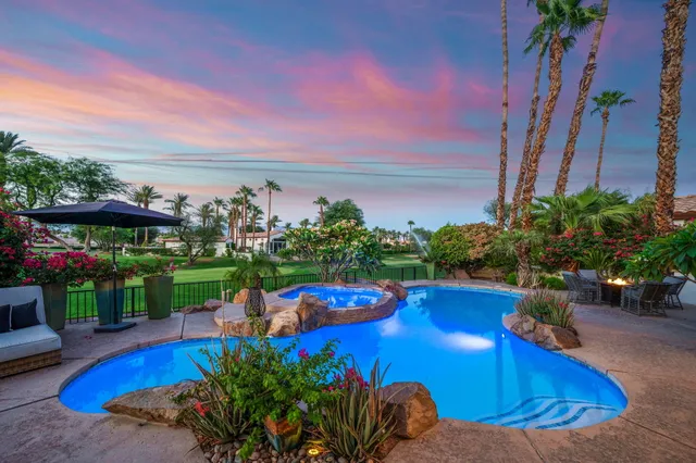 a view of a house with swimming pool and sitting area
