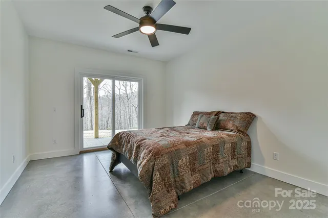a bathroom with a granite countertop toilet and sink