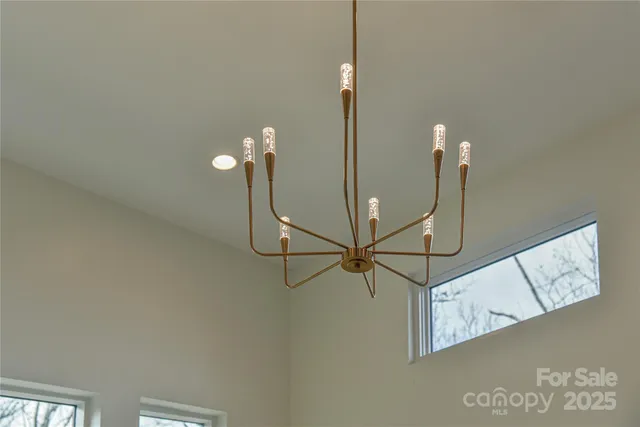 an aerial view of a house with a yard and lake