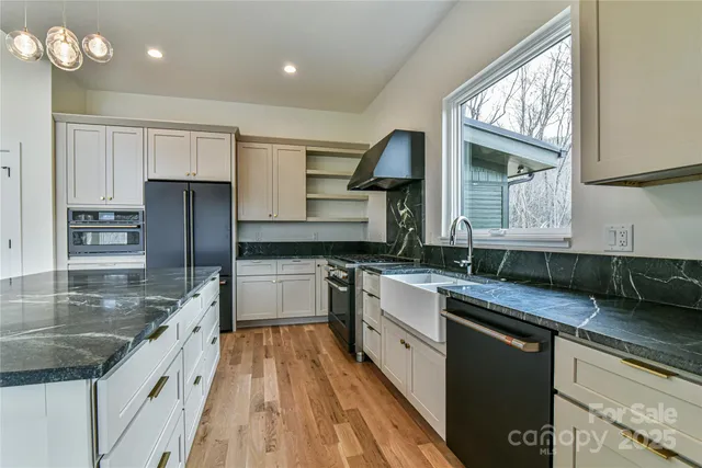 a kitchen with stainless steel appliances and cabinets