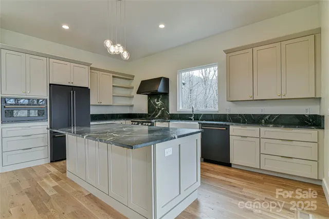 a view of an empty room with a closet wooden floor and closet