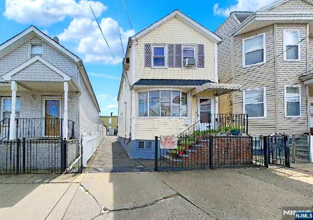 a view of a house with wooden fence