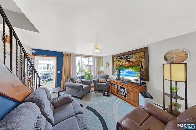 a large kitchen with stainless steel appliances a stove a sink dishwasher and a dining table with cabinets