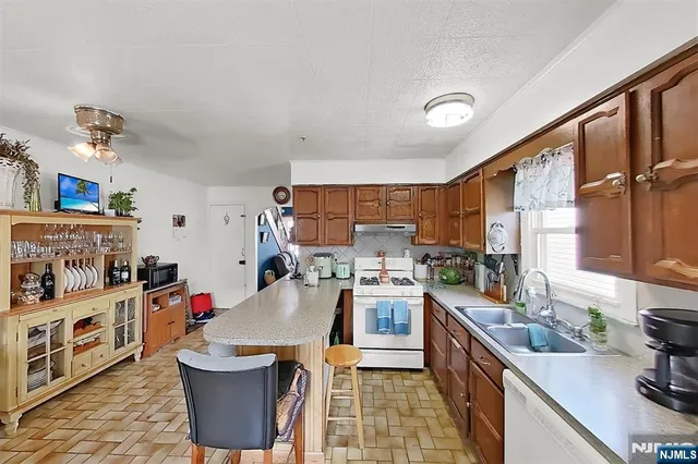 a kitchen that has a sink and a stove
